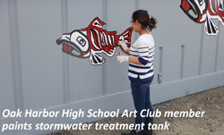 Oak Harbor High School Art Club member paints stormwater treatment tank