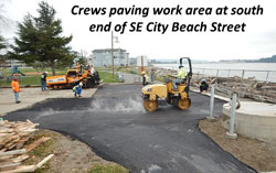 Crews paving work area at south end of SE City Beach Street